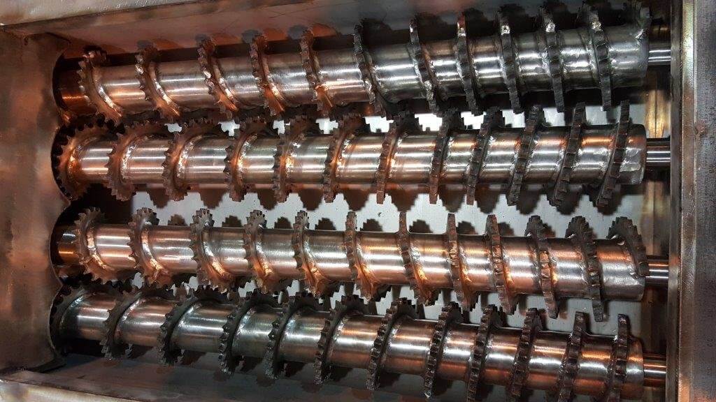 Close-up of twin cut-flight screw conveyor shafts