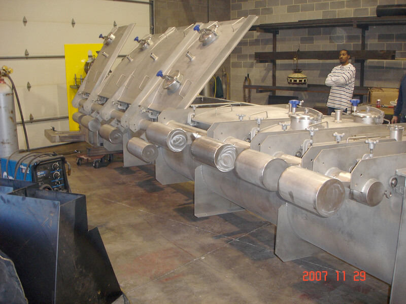 Stainless steel screw conveyors with hinged inspection covers for cheese product