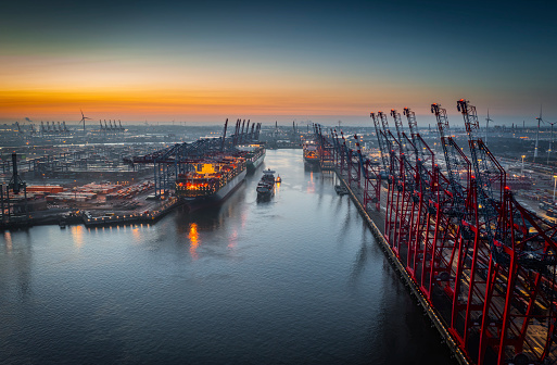 Container shipping port with cranes at dusk
