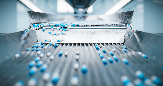 Pharmaceutical capsules on a production conveyor