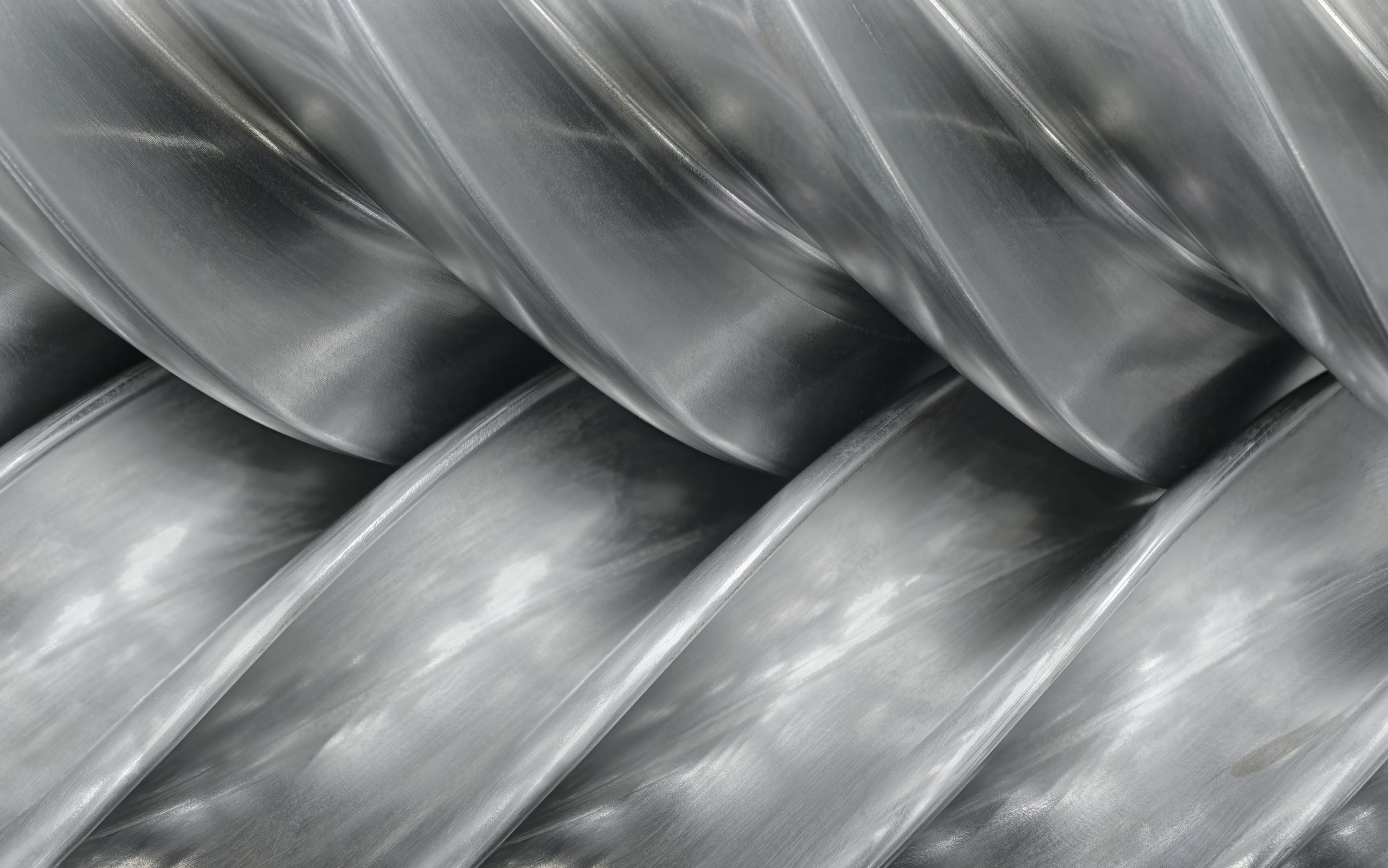 Close-up of a steel screw conveyor's helical flighting